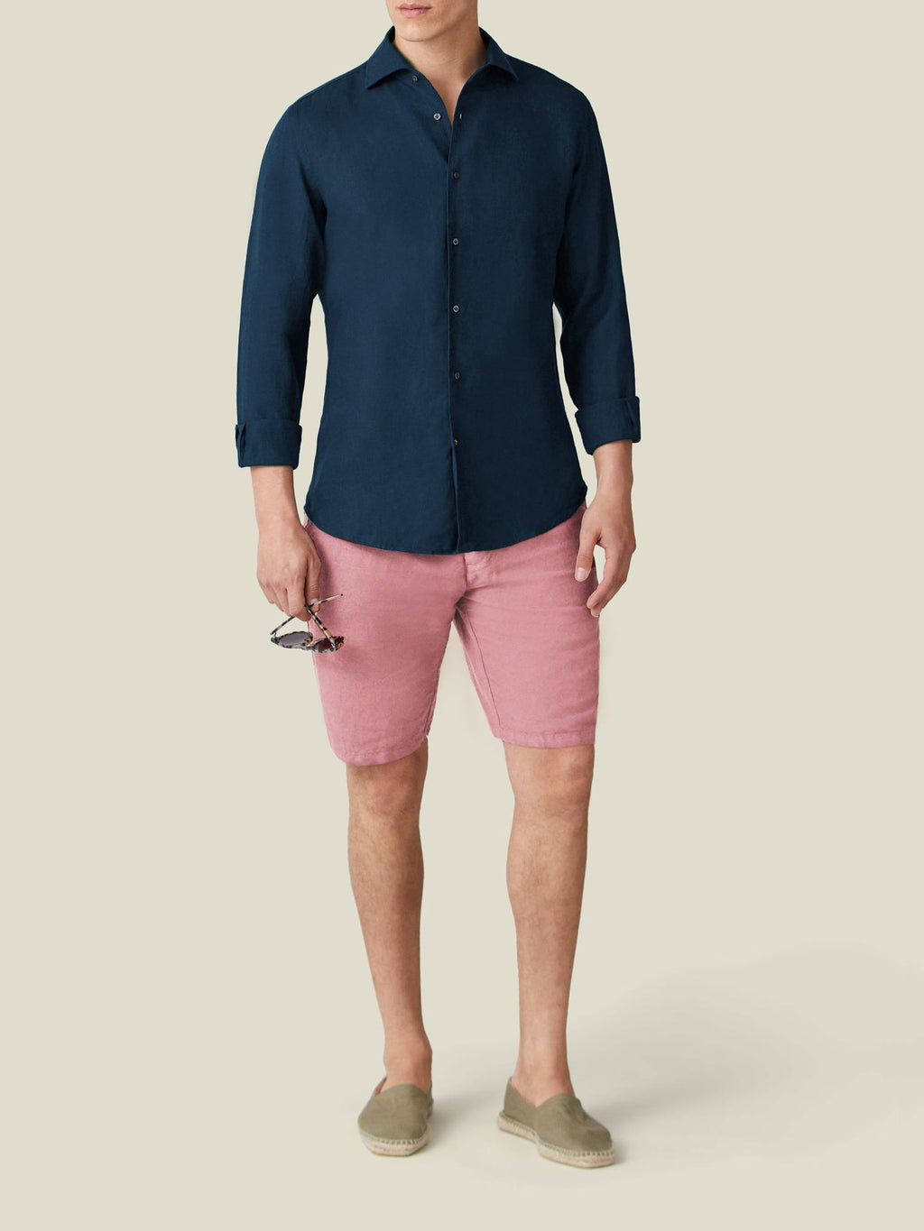Front view of a model wearing the Luca Faloni Portofino Linen Shirt in midnight blue with pink shorts.