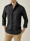Front view of a model wearing the Luca Faloni Portofino Linen Shirt in black, styled with rolled sleeves and tan chinos.