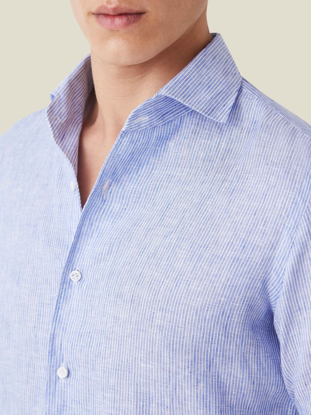 Detail shot of the Portofino Linen Shirt in Striped Classic Blue, highlighting the one-piece collar and fabric texture.