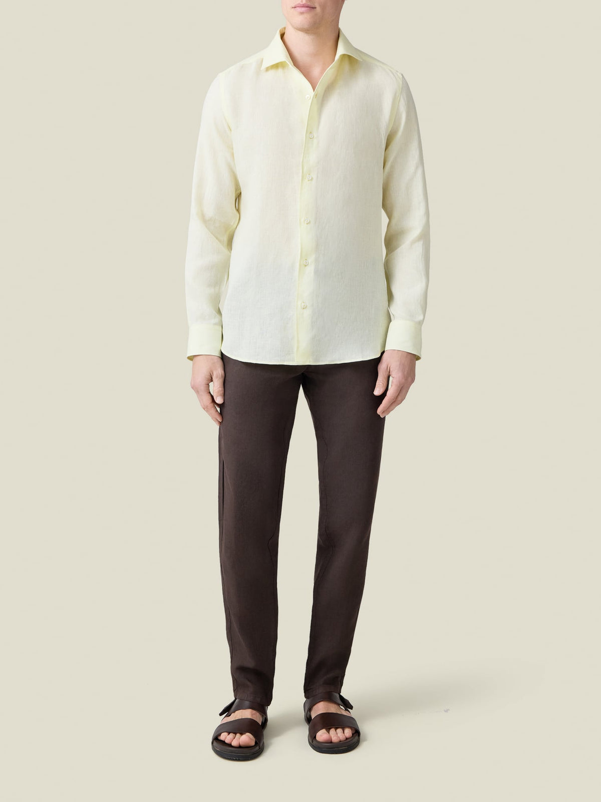 Front view of a model wearing the Luca Faloni Portofino Linen Shirt in Lemon, paired with dark trousers.