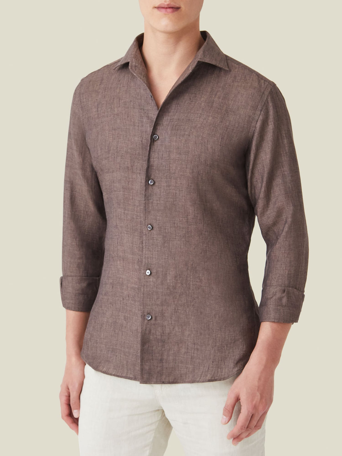 Front view of a model wearing the Luca Faloni Portofino Linen Shirt in Chocolate Brown with sleeves rolled up.