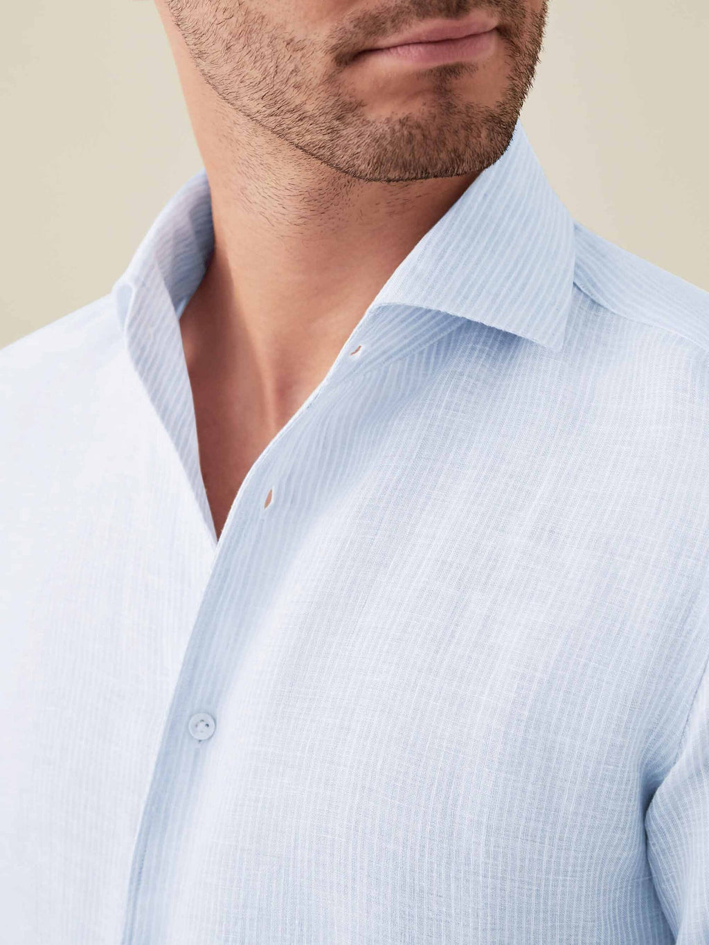 Close-up of the Portofino Linen Shirt in Striped Sky Blue, showcasing the iconic one-piece collar and fine linen texture.