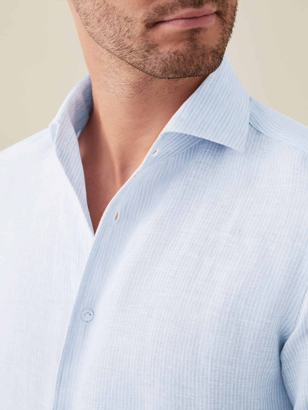 Close-up of the Portofino Linen Shirt in Striped Sky Blue, showcasing the iconic one-piece collar and fine linen texture.