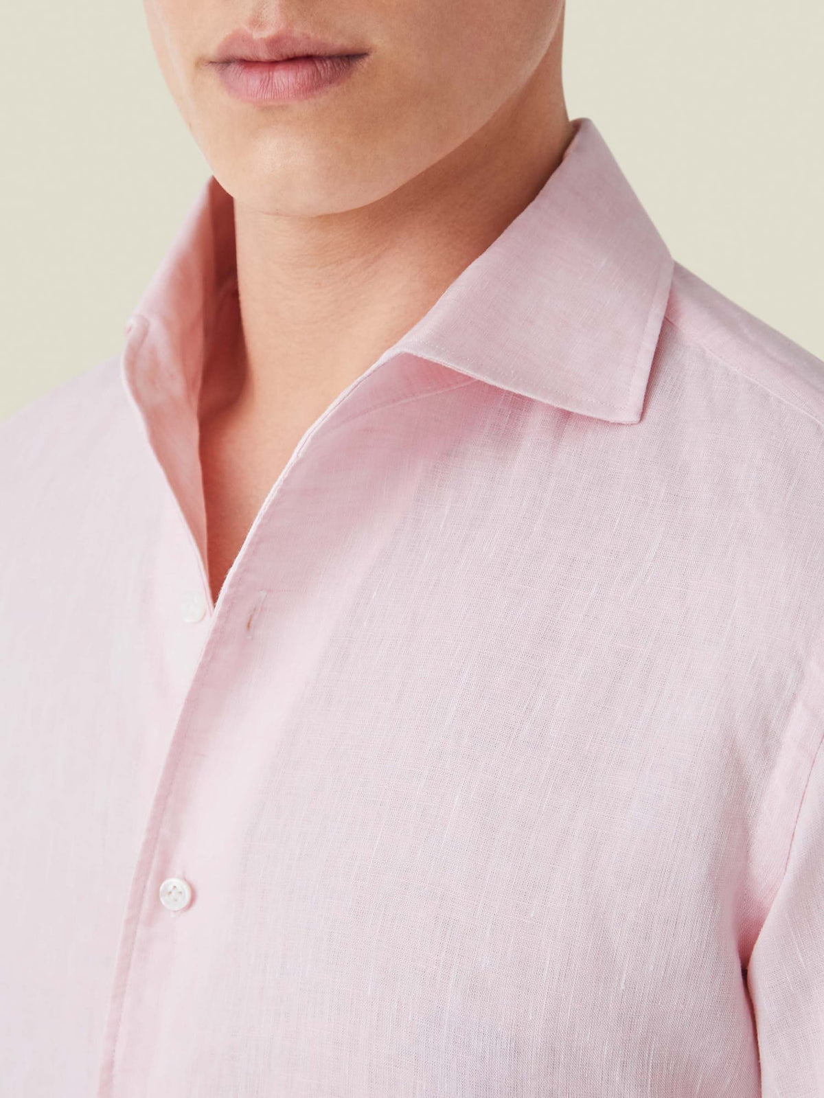 Close-up of the Portofino Linen Shirt in light pink, showing the detail of the signature one-piece collar and linen fabric.