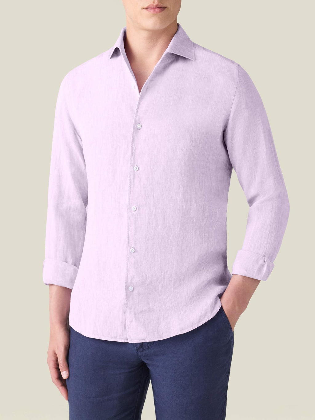 A front view of a model wearing the Luca Faloni Portofino Linen Shirt in lilac with rolled-up sleeves.