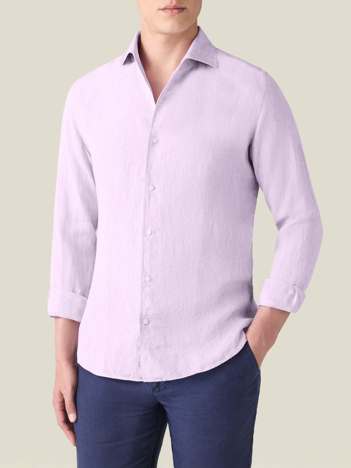 A front view of a model wearing the Luca Faloni Portofino Linen Shirt in lilac with rolled-up sleeves.