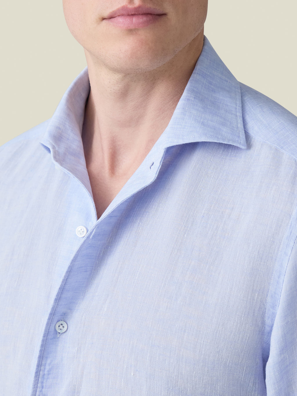 A close-up of the Portofino Linen Shirt in sky blue, focusing on the signature one-piece collar and fine linen texture.