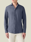 Front view of a man wearing the Luca Faloni Portofino Linen Shirt in Payne's Grey, paired with light-coloured trousers.