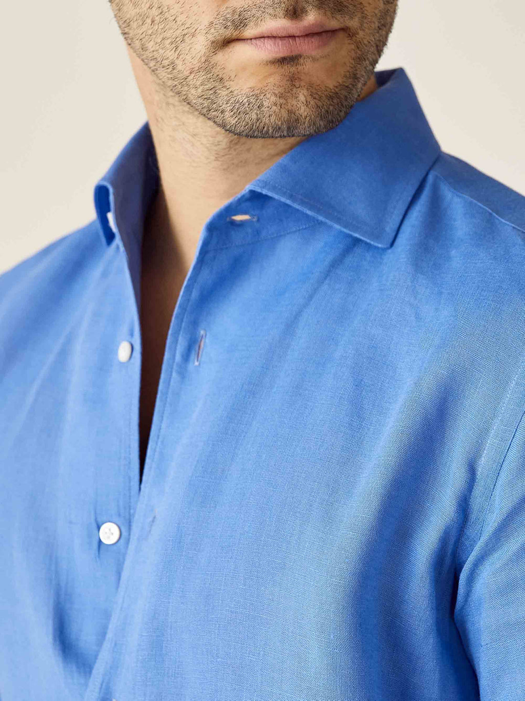 Close-up of the Portofino Linen Shirt in Capri Blue, showcasing the signature one-piece collar and linen texture.