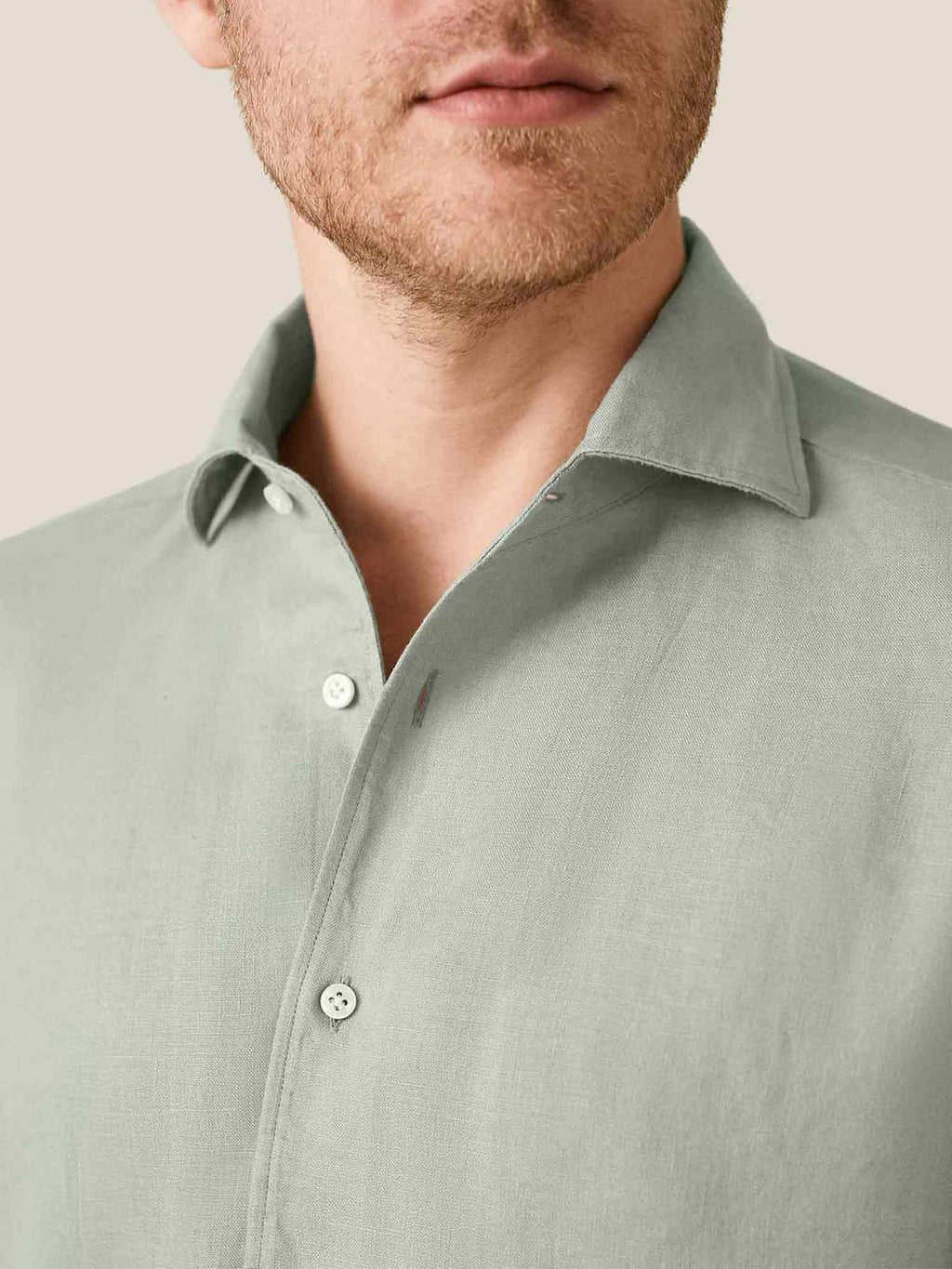 Close-up detail of the sage green Portofino Linen Shirt, showing its signature Paramontura one-piece collar.