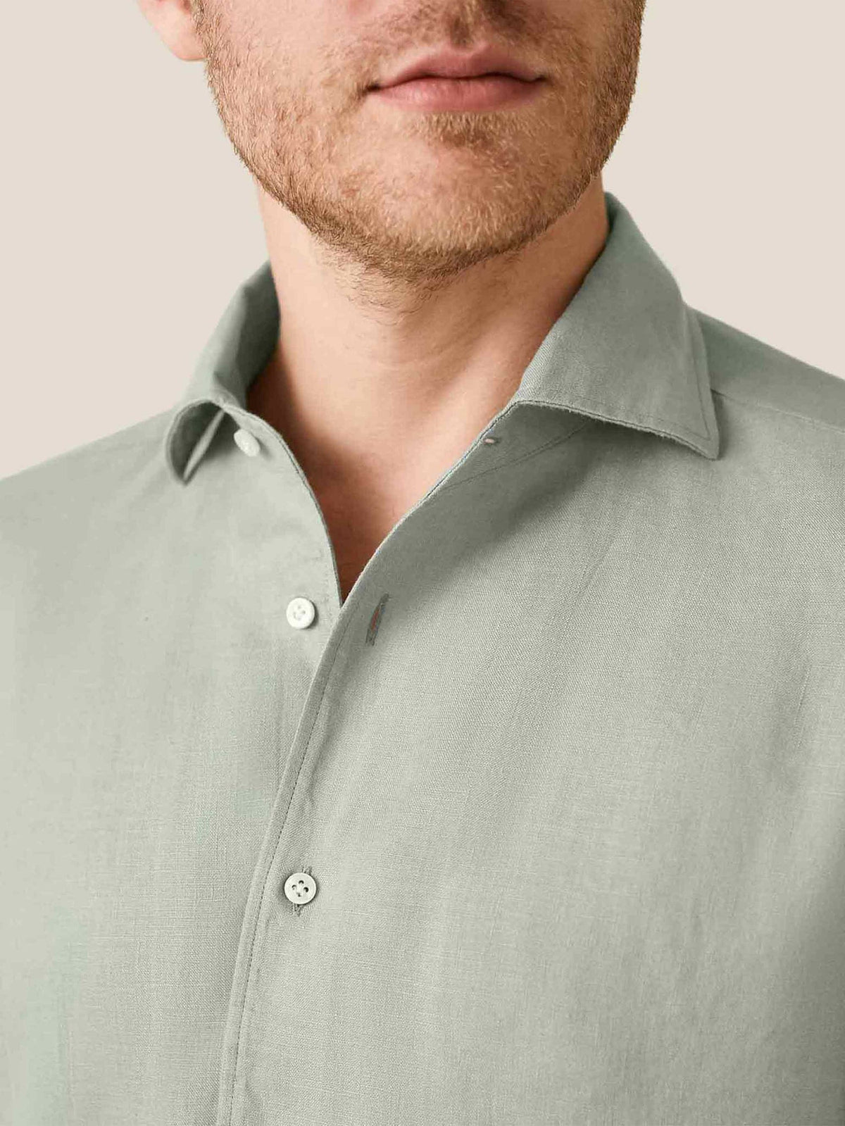 Close-up detail of the sage green Portofino Linen Shirt, showing its signature Paramontura one-piece collar.