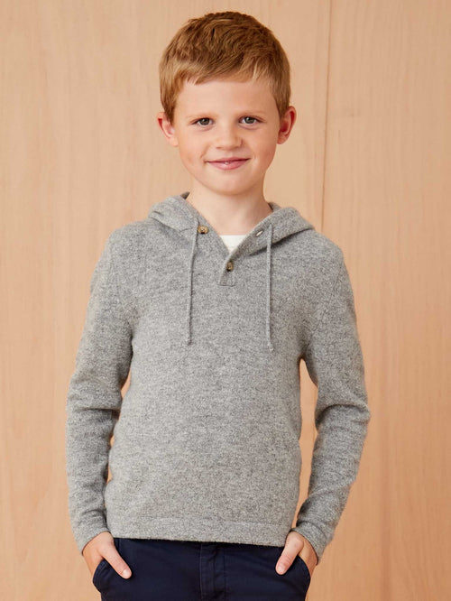 Front view of a young boy wearing the Luca Faloni Junior Cashmere Hoodie in Dolomiti Grey.