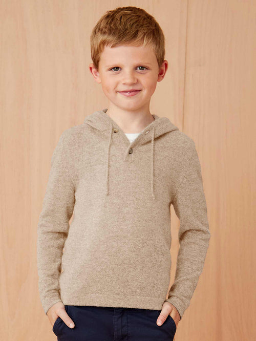 Front view of a young boy modelling the Luca Faloni Junior Cashmere Hoodie in Camel Beige.