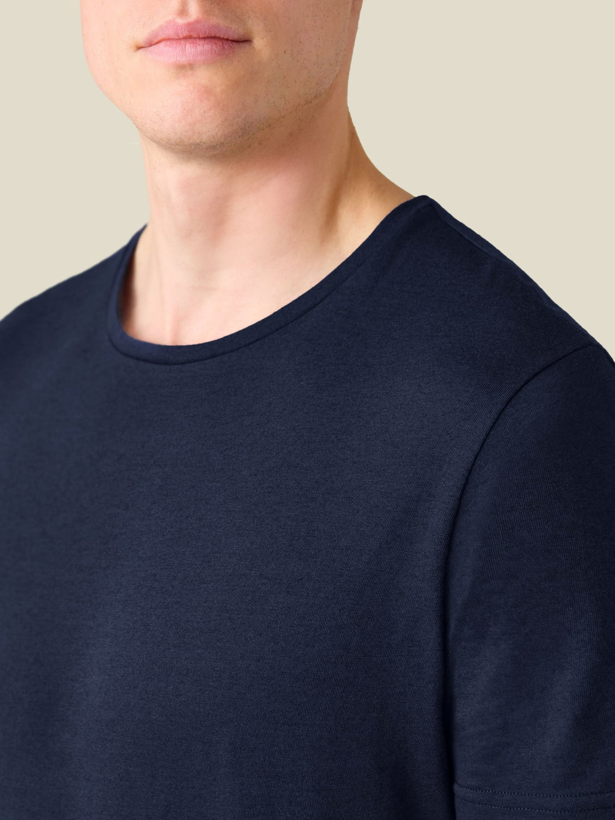 A close-up of the Midnight Blue Cashmere Cotton T-Shirt, showing the crew neckline and soft mélange fabric.