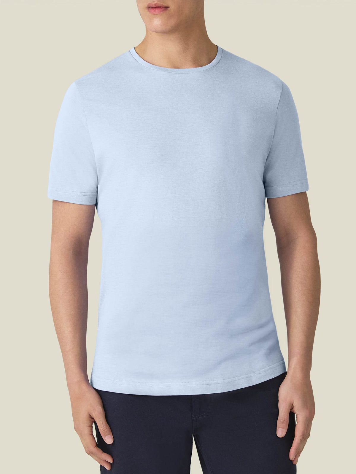 Model from the front wearing the light blue Cashmere Cotton T-Shirt, showcasing its classic fit and crew neckline.