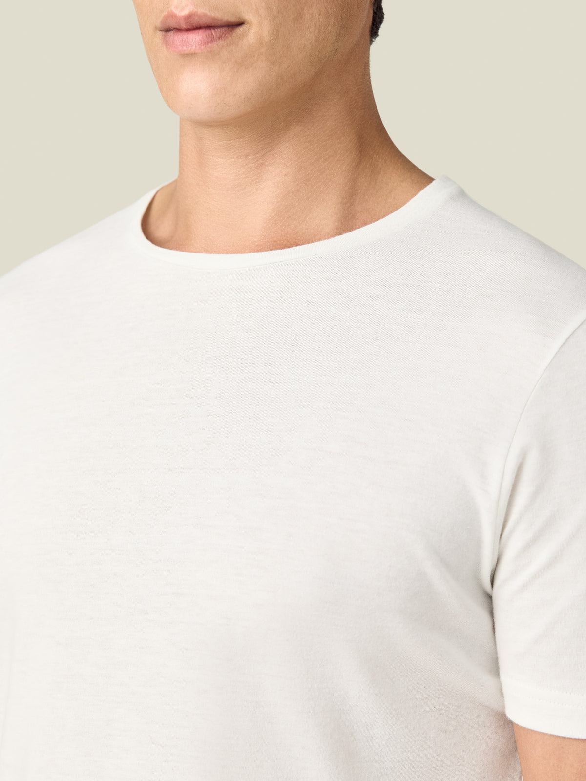 Close-up of a model wearing the Luca Faloni Cashmere cotton T-Shirt in white, showing the crew neckline.