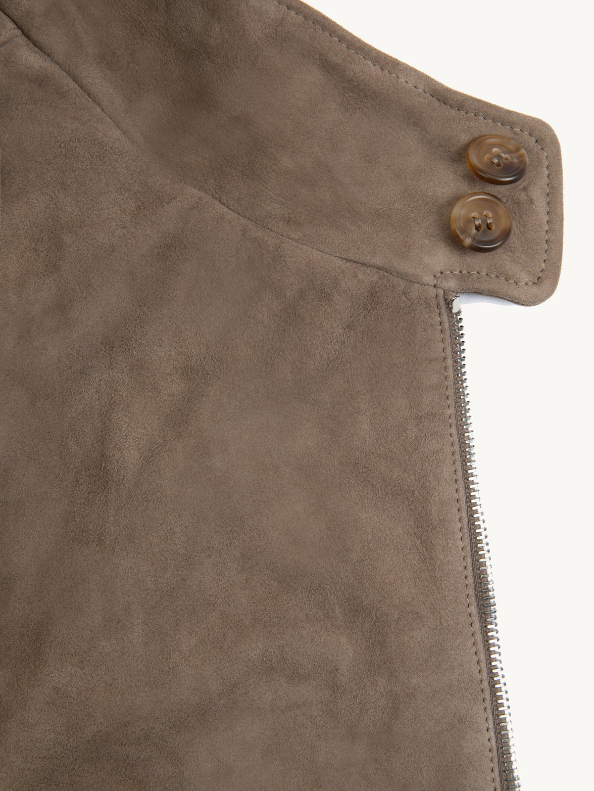 A close-up of the Hazelnut Brown Classic Bomber Jacket's goatskin suede, showing the double horn buttoned collar.