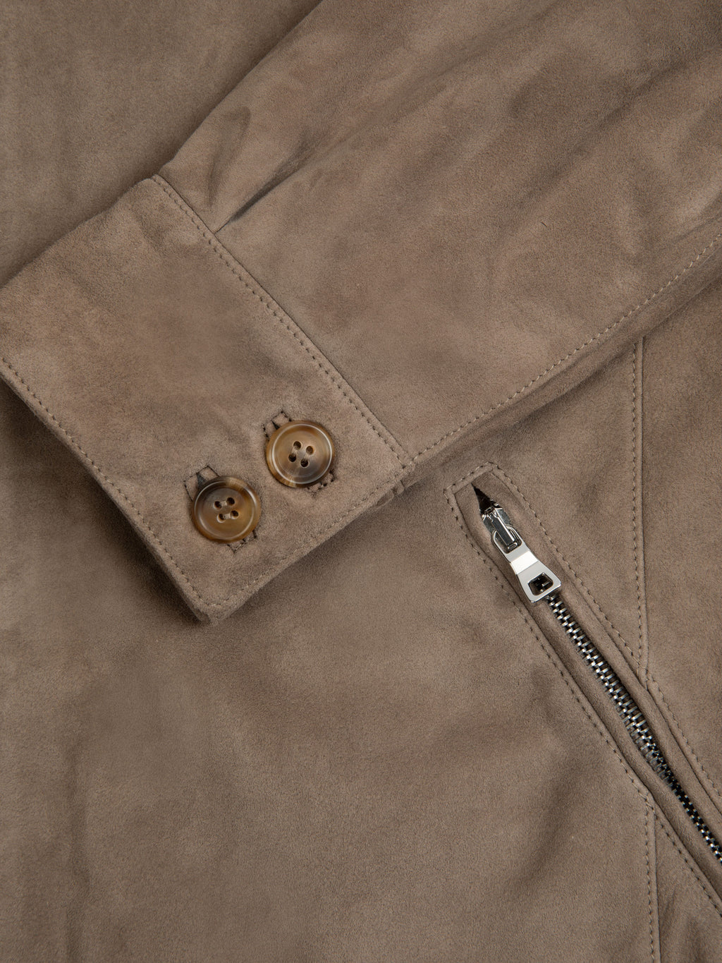 Detail of the cuff on the Hazelnut Brown Classic Bomber Jacket, showing the double horn buttons and zipped front pocket.