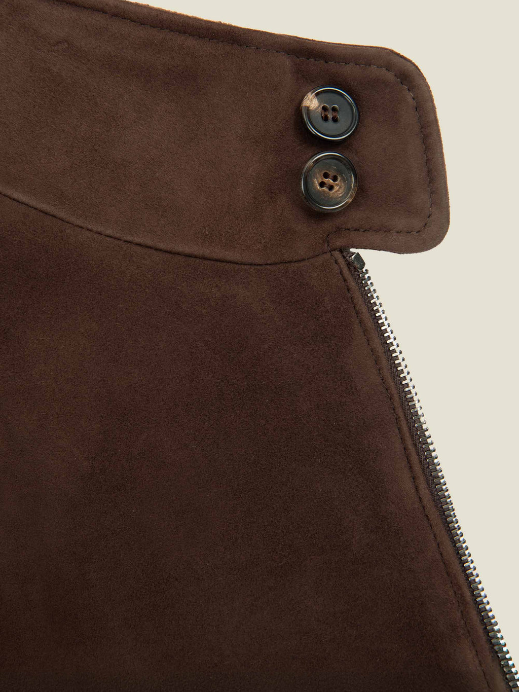 Close-up of the double horn buttons on the goatskin suede collar of the Chocolate Brown Classic Bomber Jacket.