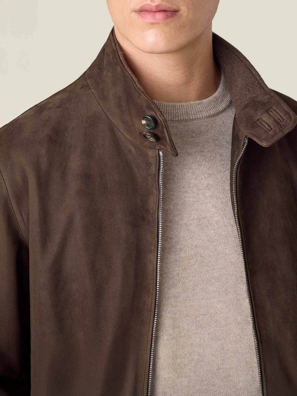 Close-up of the Classic Bomber Jacket in Chocolate Brown, showing the suede texture and double horn button collar.