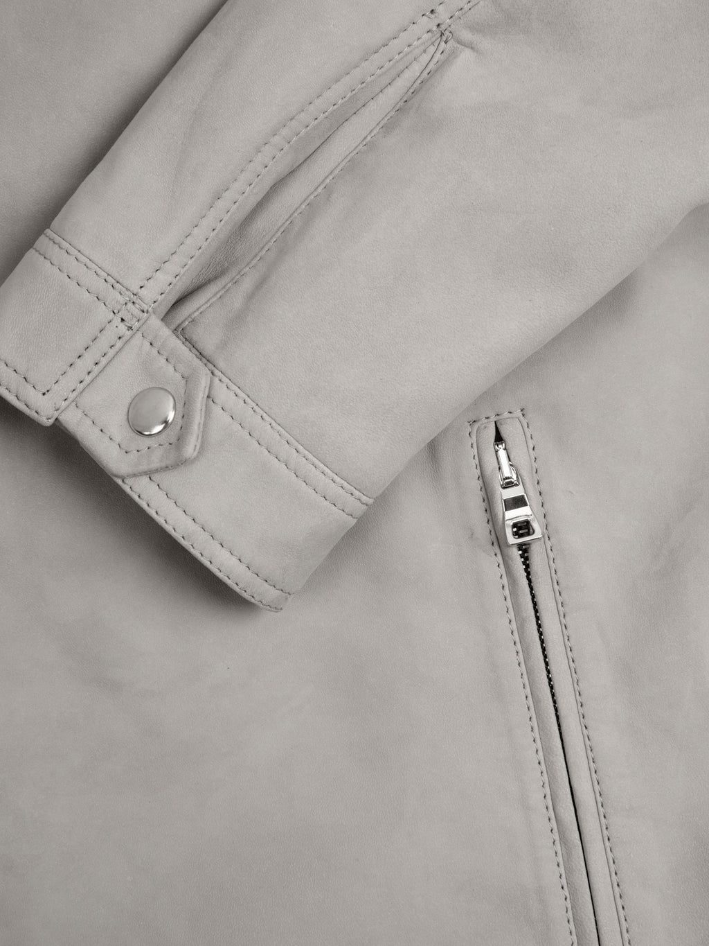 Close-up of the sleeve cuff and zipped pocket on the Luca Faloni Classic Racer Jacket in light grey goatskin suede.