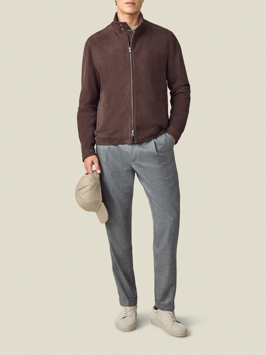Front view of a model wearing the Luca Faloni Classic Racer Jacket in chocolate brown, paired with grey trousers.