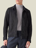 A front view of a man wearing the Luca Faloni Classic Racer Jacket in black goatskin suede over a grey turtleneck.