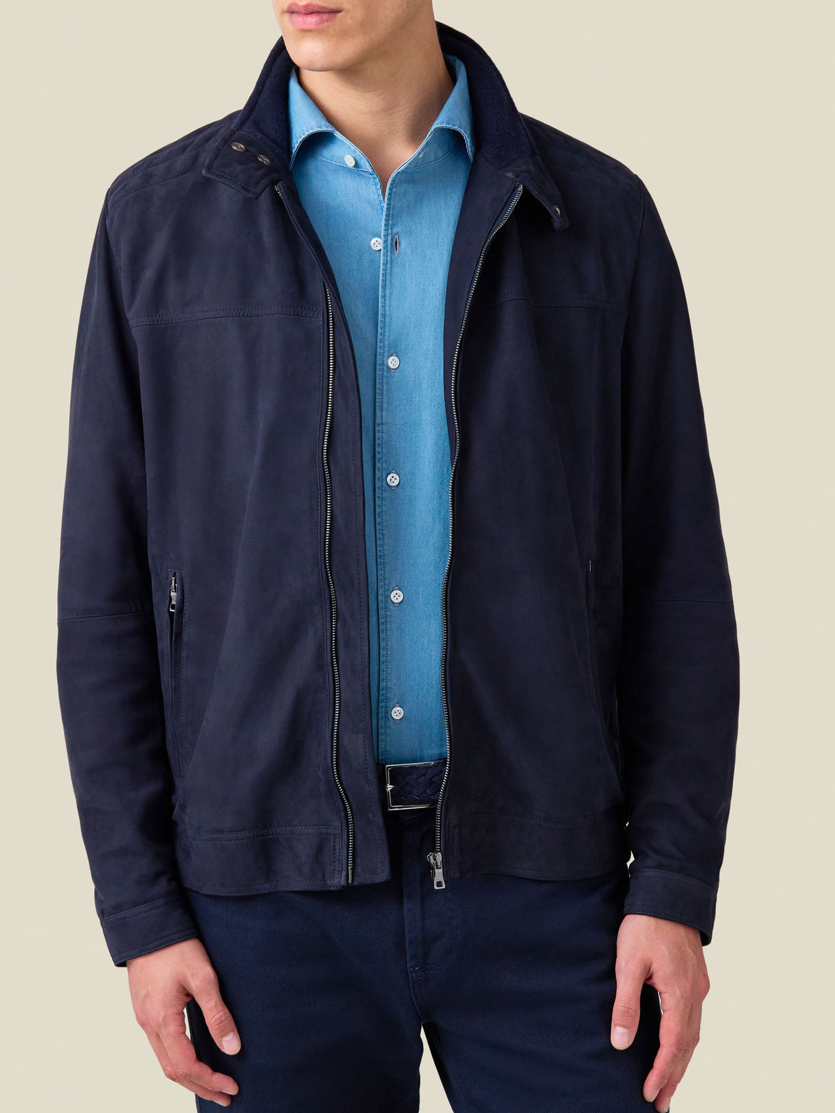 Front view of a model wearing the navy blue Classic Racer Jacket with a light blue collared shirt and navy trousers.