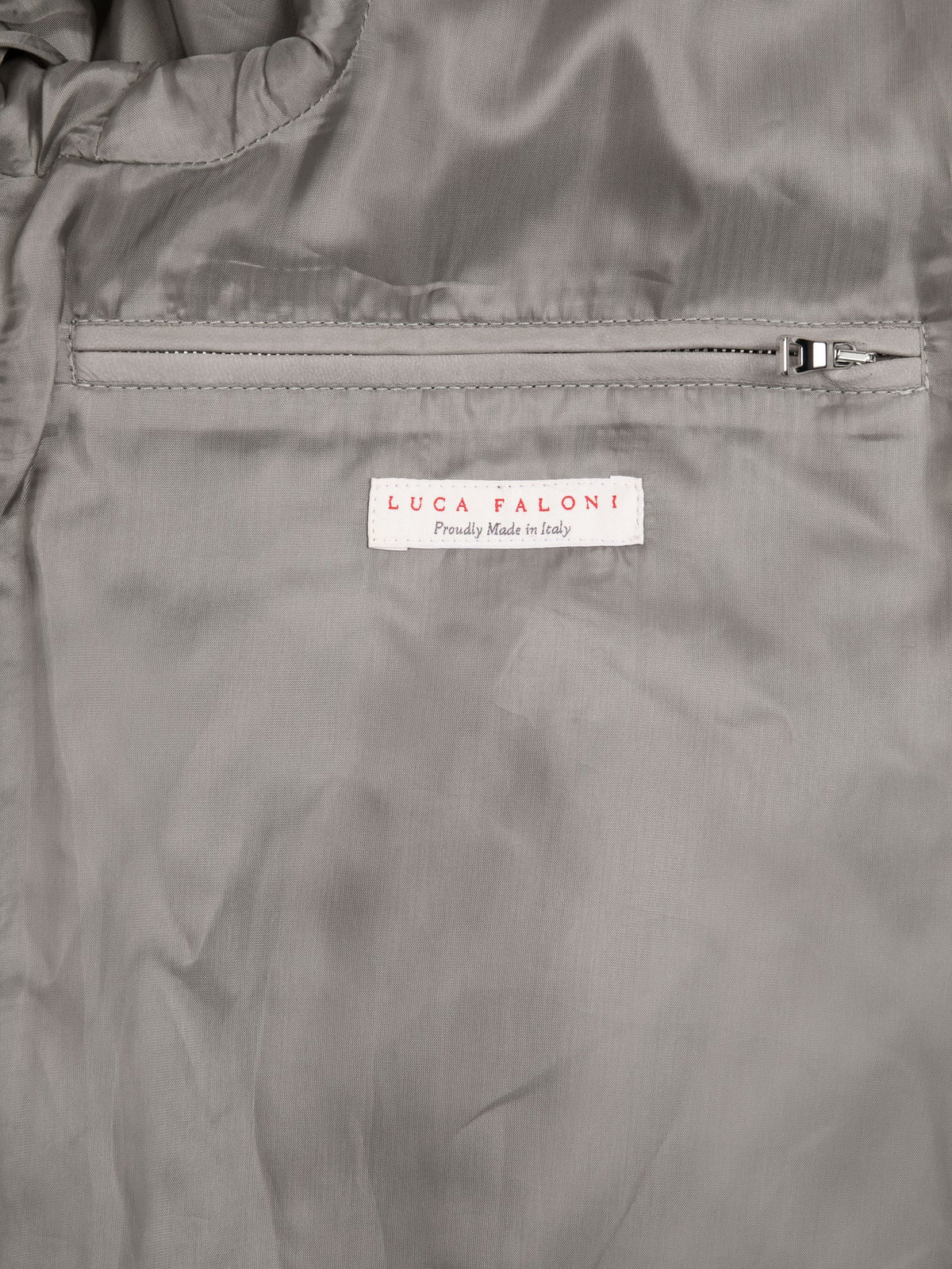 Close-up of the internal zip pocket and Luca Faloni 'Made in Italy' label inside the light grey Classic Racer Jacket.