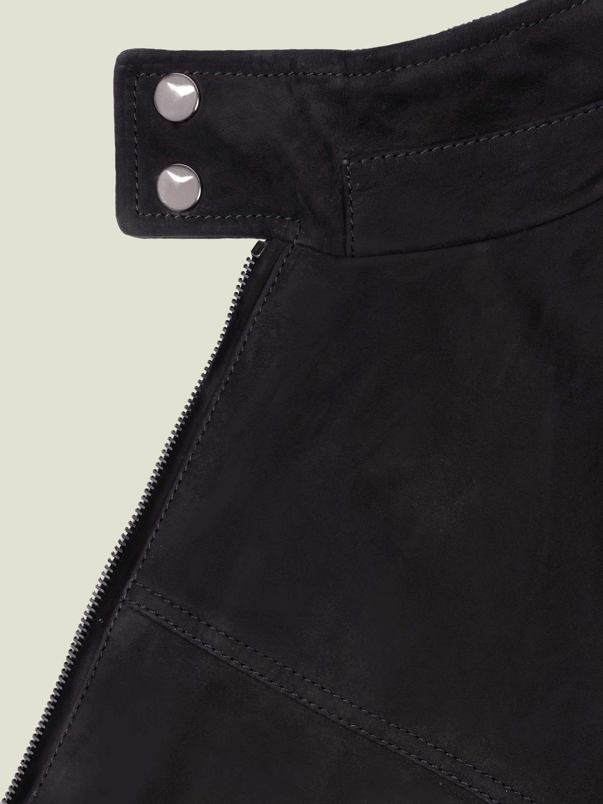 Detail of the double press-studded buttons on the collar of the black goatskin suede Classic Racer Jacket.