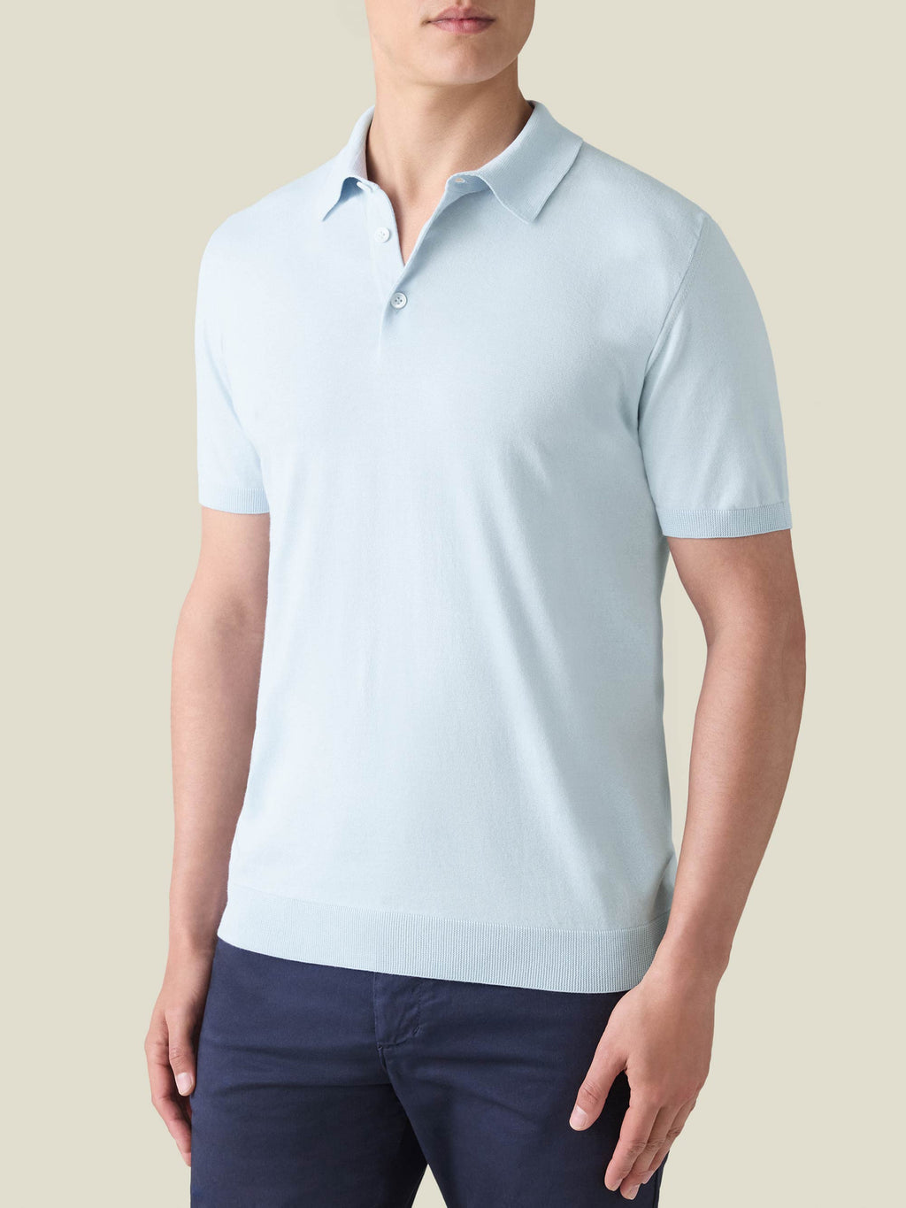 Model wearing the Luca Faloni Knitted Cotton Polo in Light Blue.