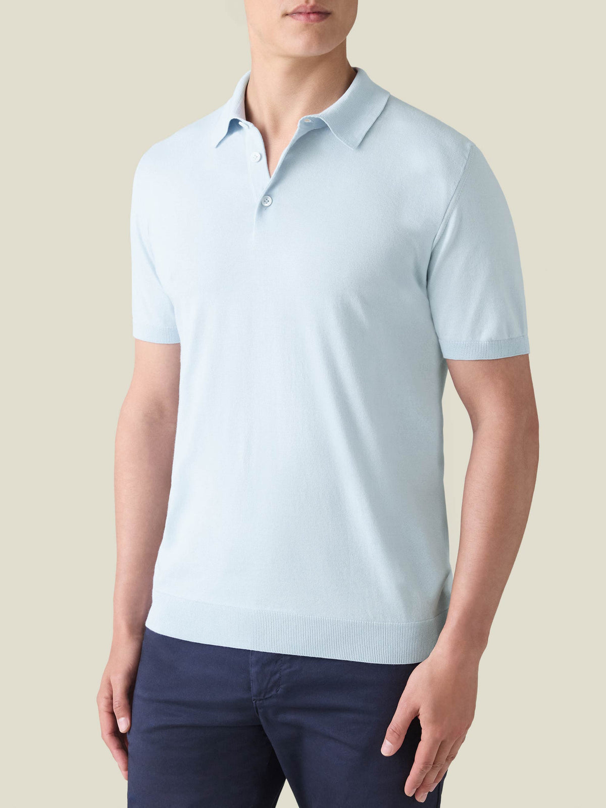 Model wearing the Luca Faloni Knitted Cotton Polo in Light Blue.