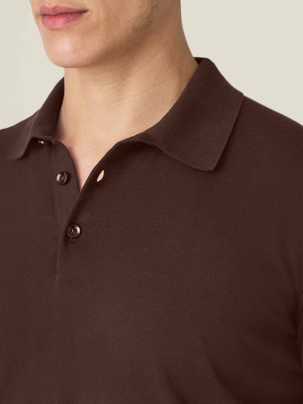 Close-up of the knitted collar and mother-of-pearl buttons on the men's Chocolate Brown Knitted Cotton Polo.