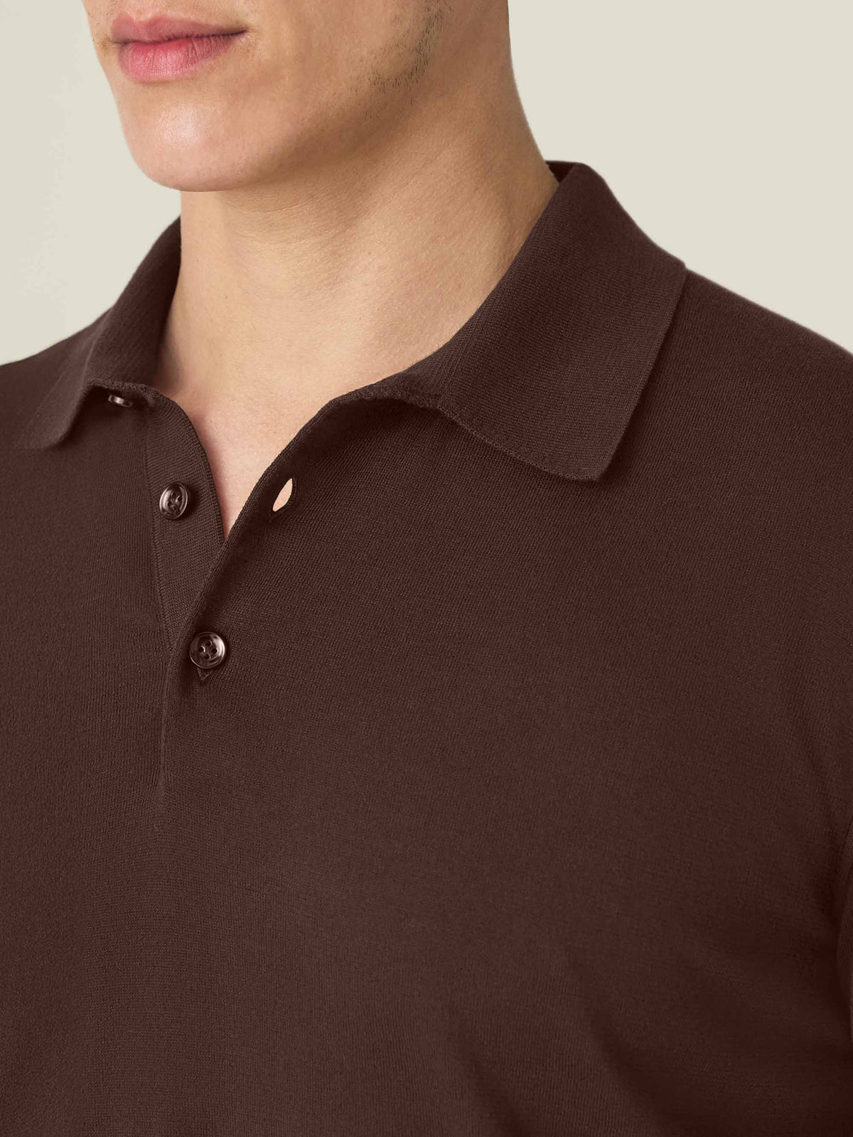 Close-up of the knitted collar and mother-of-pearl buttons on the men's Chocolate Brown Knitted Cotton Polo.