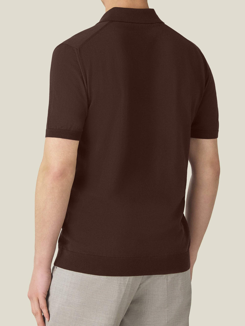 Back view of a man wearing the Chocolate Brown Knitted Cotton Polo.