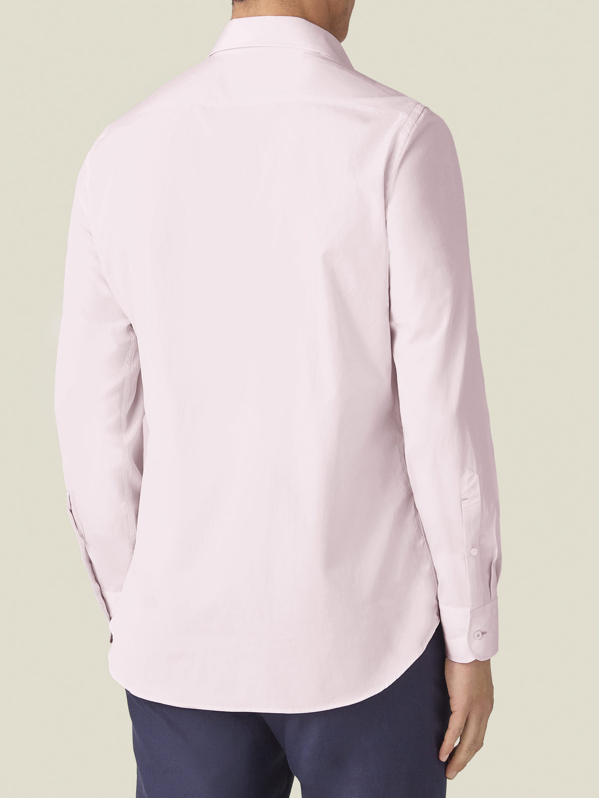 Back view of a man wearing the Luca Faloni Lightweight Poplin Cotton Shirt in light pink, showing the fit and rounded hem.