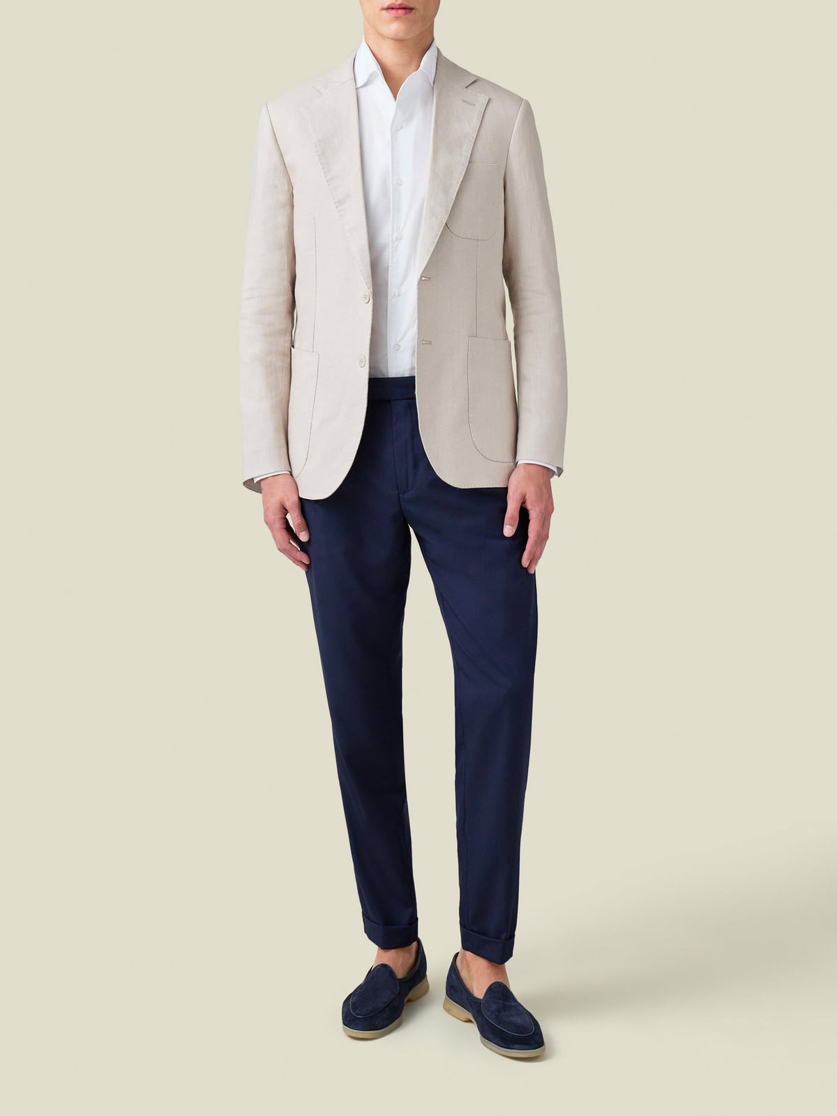 A model wears the Luca Faloni white Lightweight Poplin Cotton Shirt with a beige blazer, navy trousers, and navy loafers.