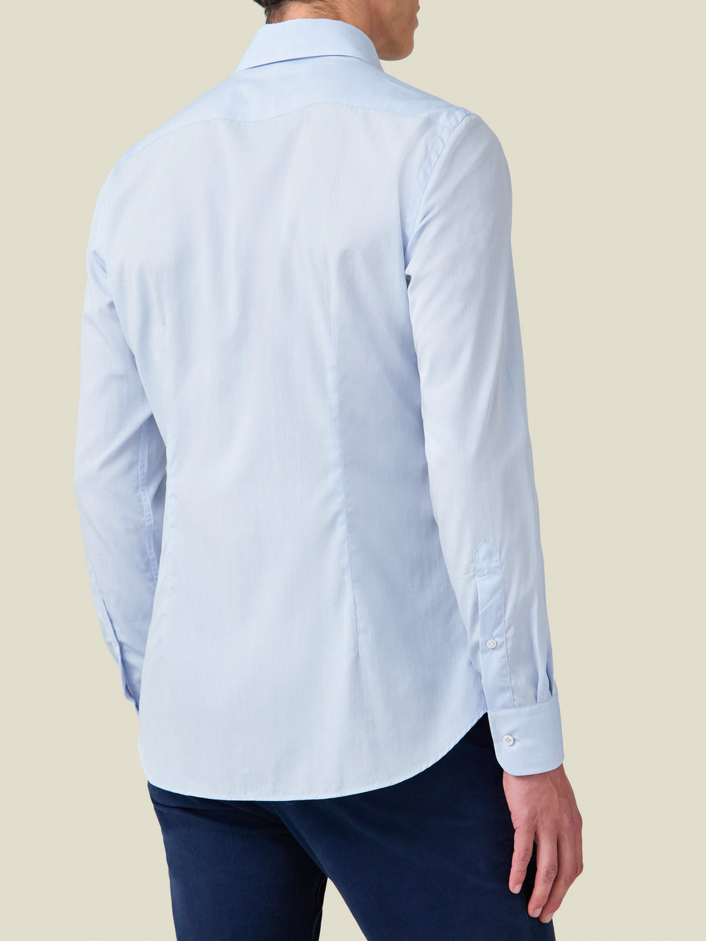Back view of a model wearing the Light Blue Lightweight Poplin Cotton Shirt, showcasing the clean lines and tailored fit.