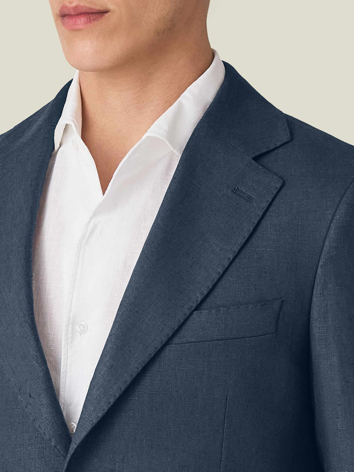 Close-up of the Navy Blue Linen Suit blazer, highlighting the notch lapel, chest pocket, and textured linen fabric.