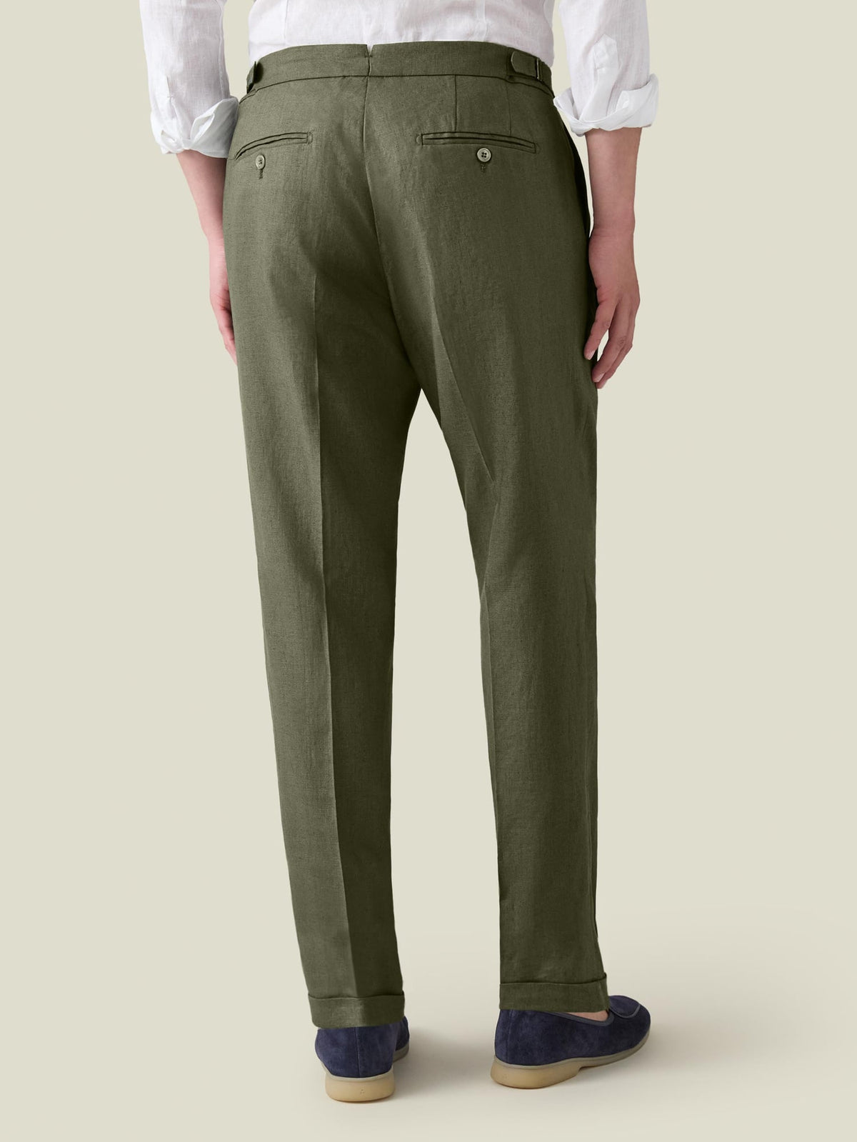 Back view of a man wearing Luca Faloni's Olive Green Linen Trousers, showcasing the tailored fit from behind.