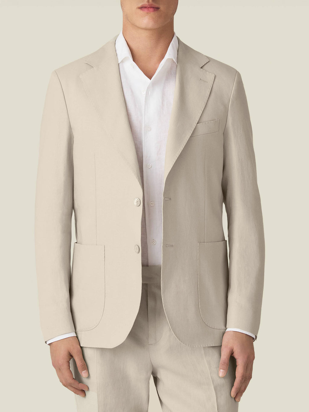 Front view of a model wearing the Luca Faloni Sand Linen Suit over a white shirt, showcasing the blazer's tailored fit.