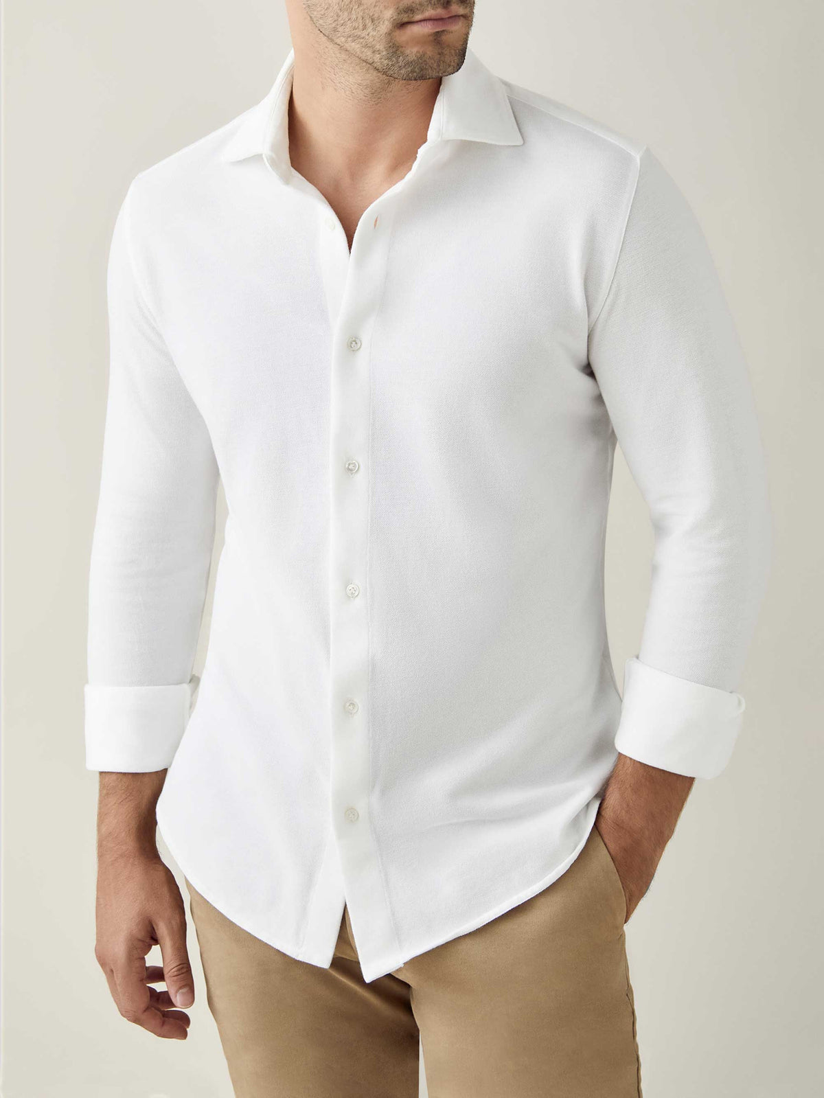 Front view of a model wearing the Luca Faloni White Silk-Cotton Piqué Shirt, styled with khaki trousers.