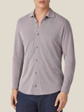 Front view of a model wearing the Silk-Cotton Piqué Shirt in Nocciola Brown, paired with dark blue jeans.