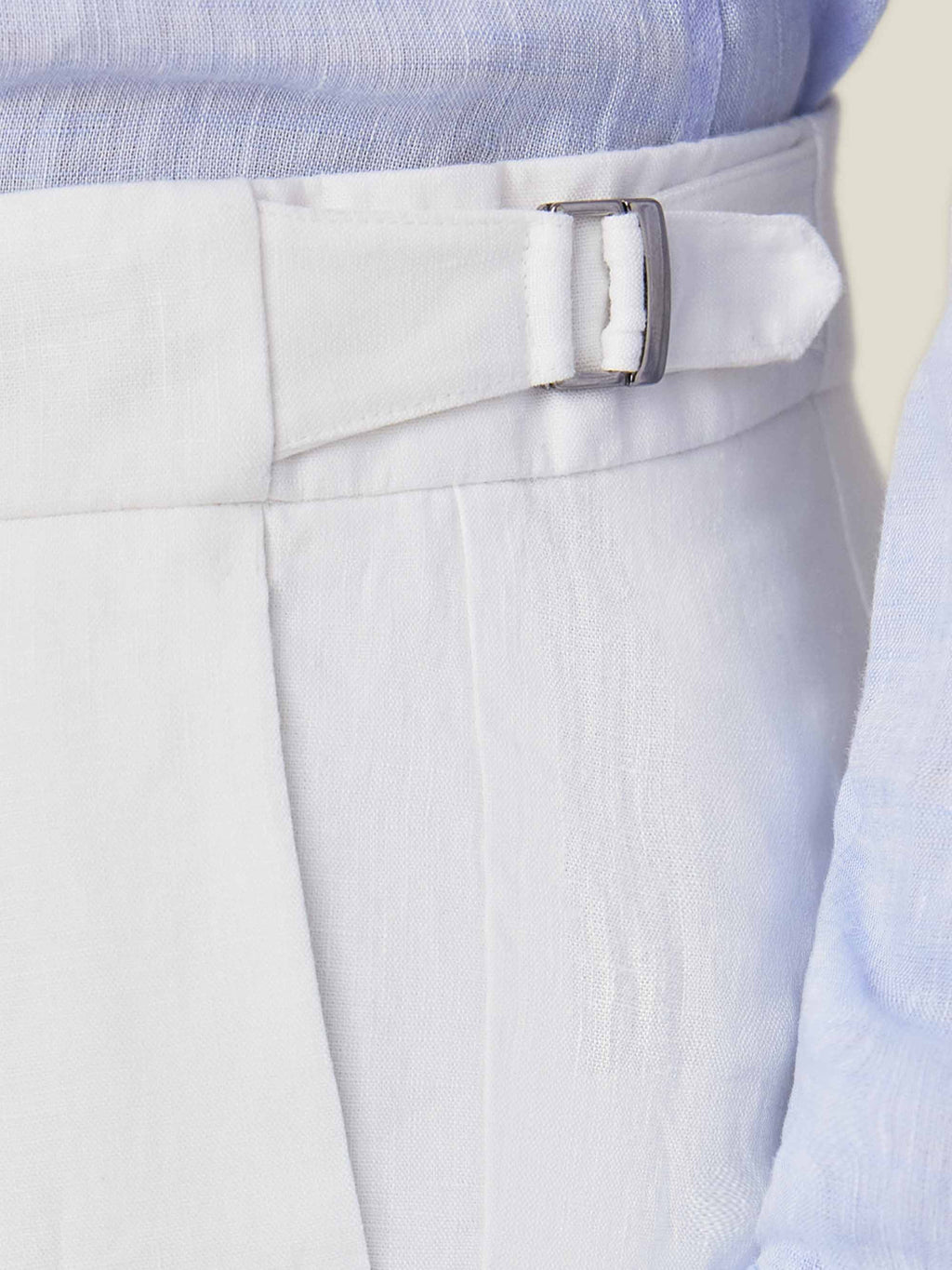 Close-up of the side adjuster buckle on the Luca Faloni White Linen Elegant Trousers, highlighting the fabric's texture.