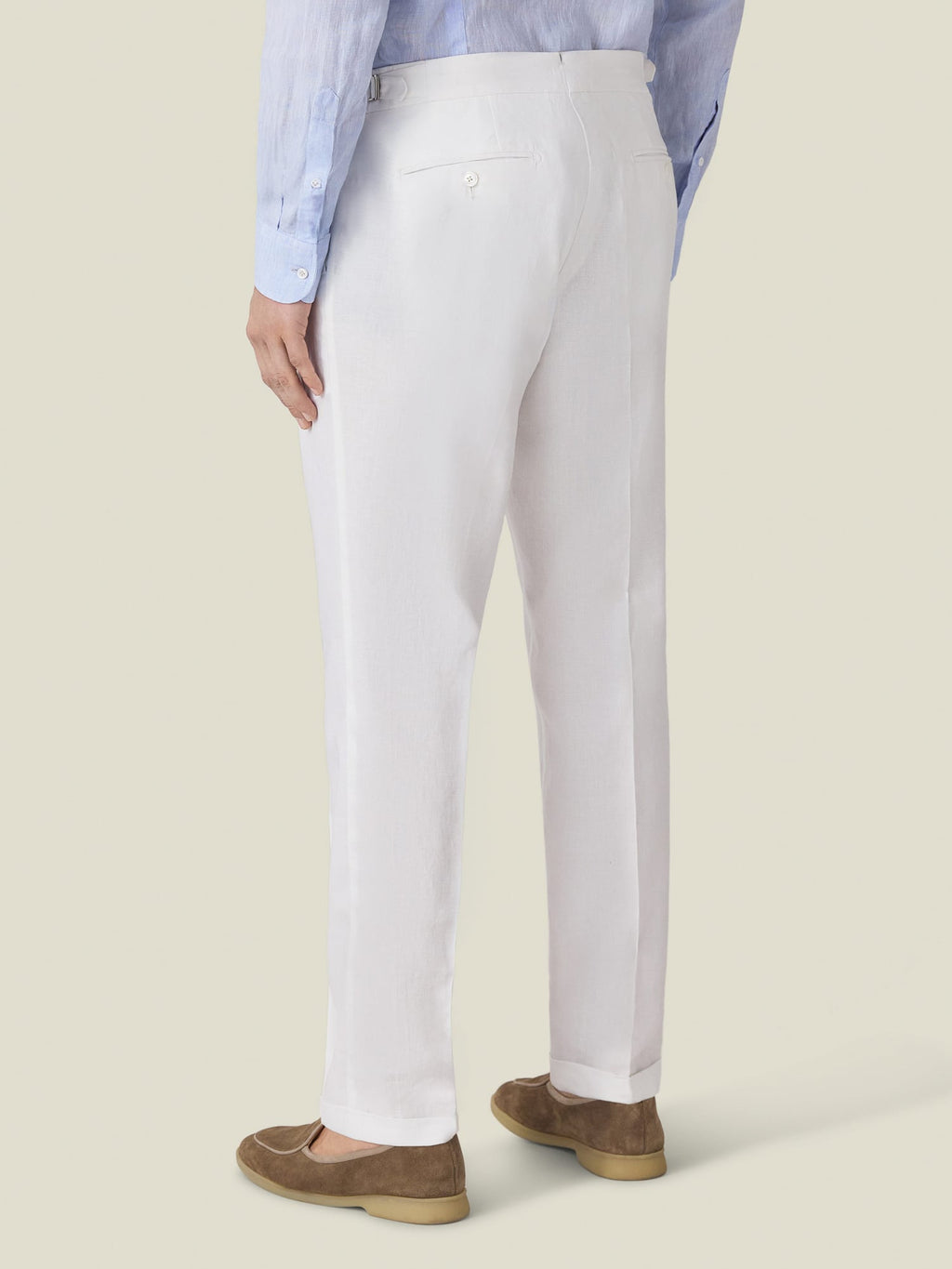 Back view of the Luca Faloni Linen Elegant Trousers in white, styled with a blue shirt and brown suede loafers.