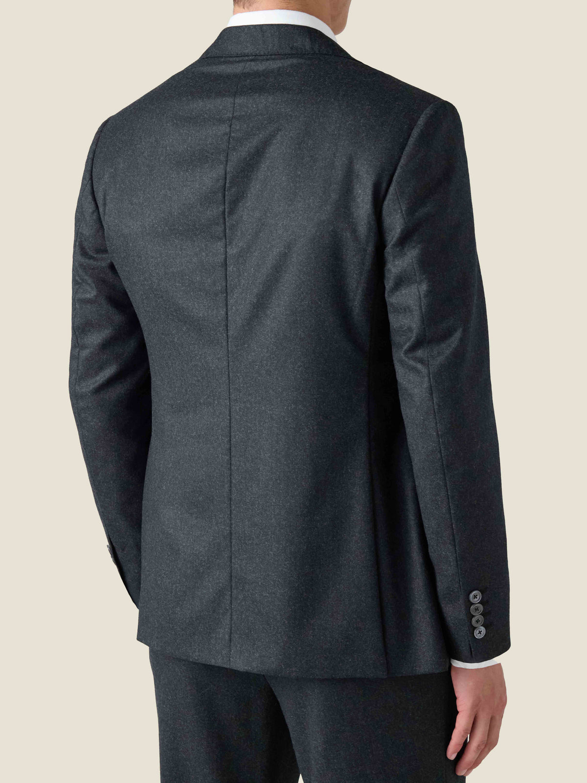 A rear view of the Charcoal Grey Wool Blazer, showcasing the slim tailored fit, soft brushed wool, and surgeon's cuff.