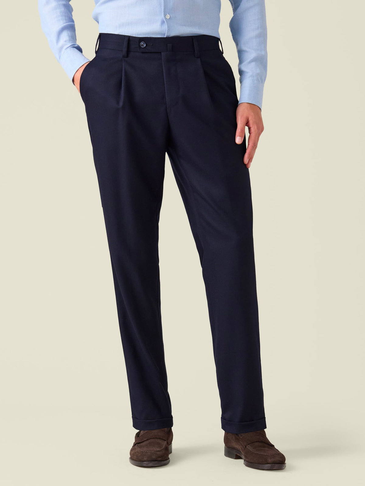 Front view of a model wearing the Midnight Blue Classic Wool Trousers, showcasing the single pleats and cuffed hems.