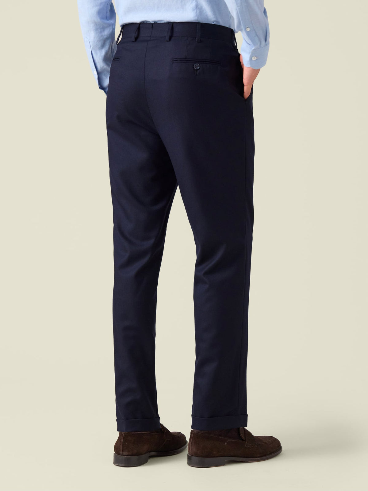 Back view of a model wearing the Midnight Blue Classic Wool Trousers, highlighting the slim straight fit and cuffed hems.