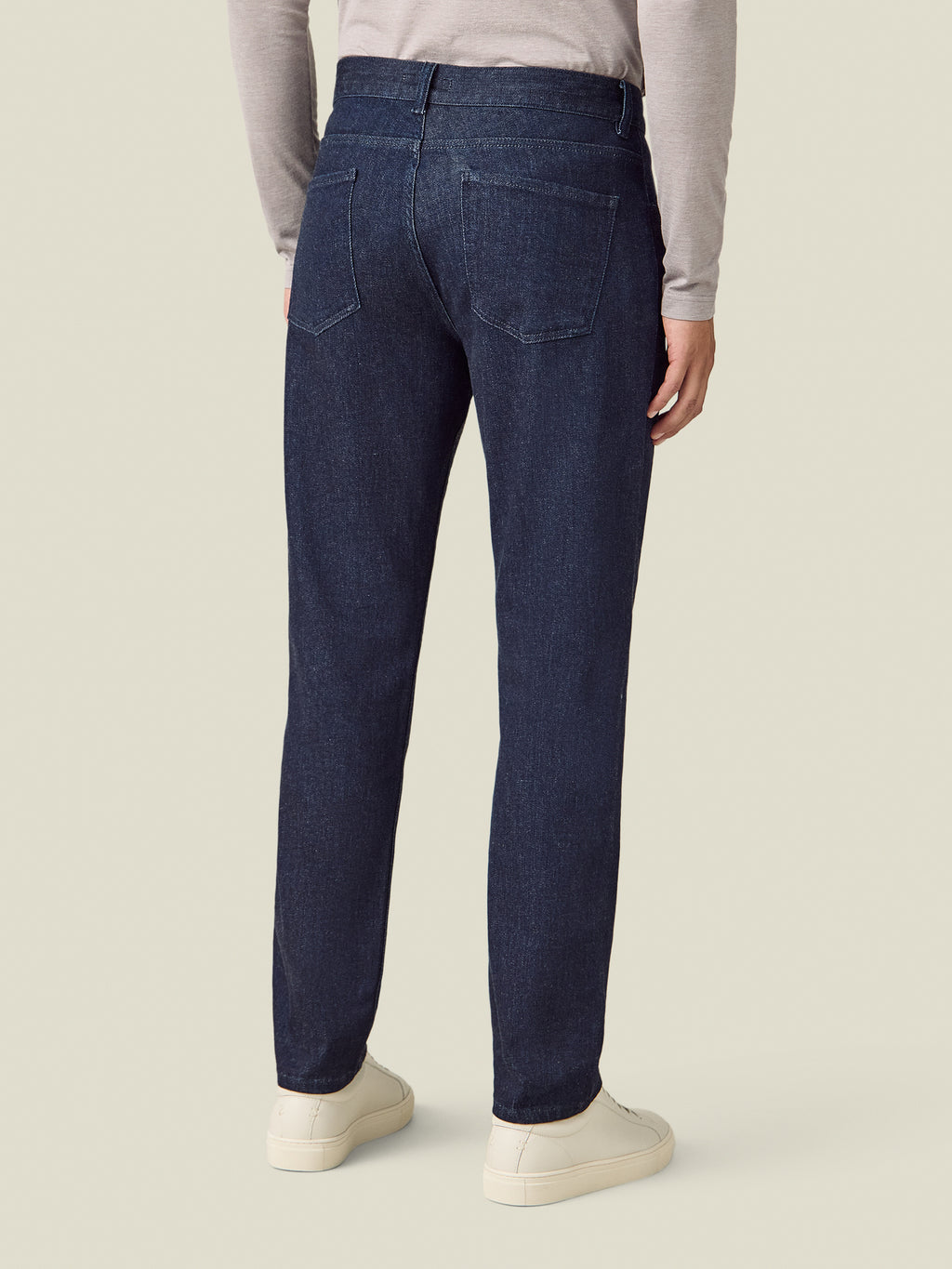 Back view of a model wearing the Luca Faloni Cashmere Denim Jeans in dark blue.