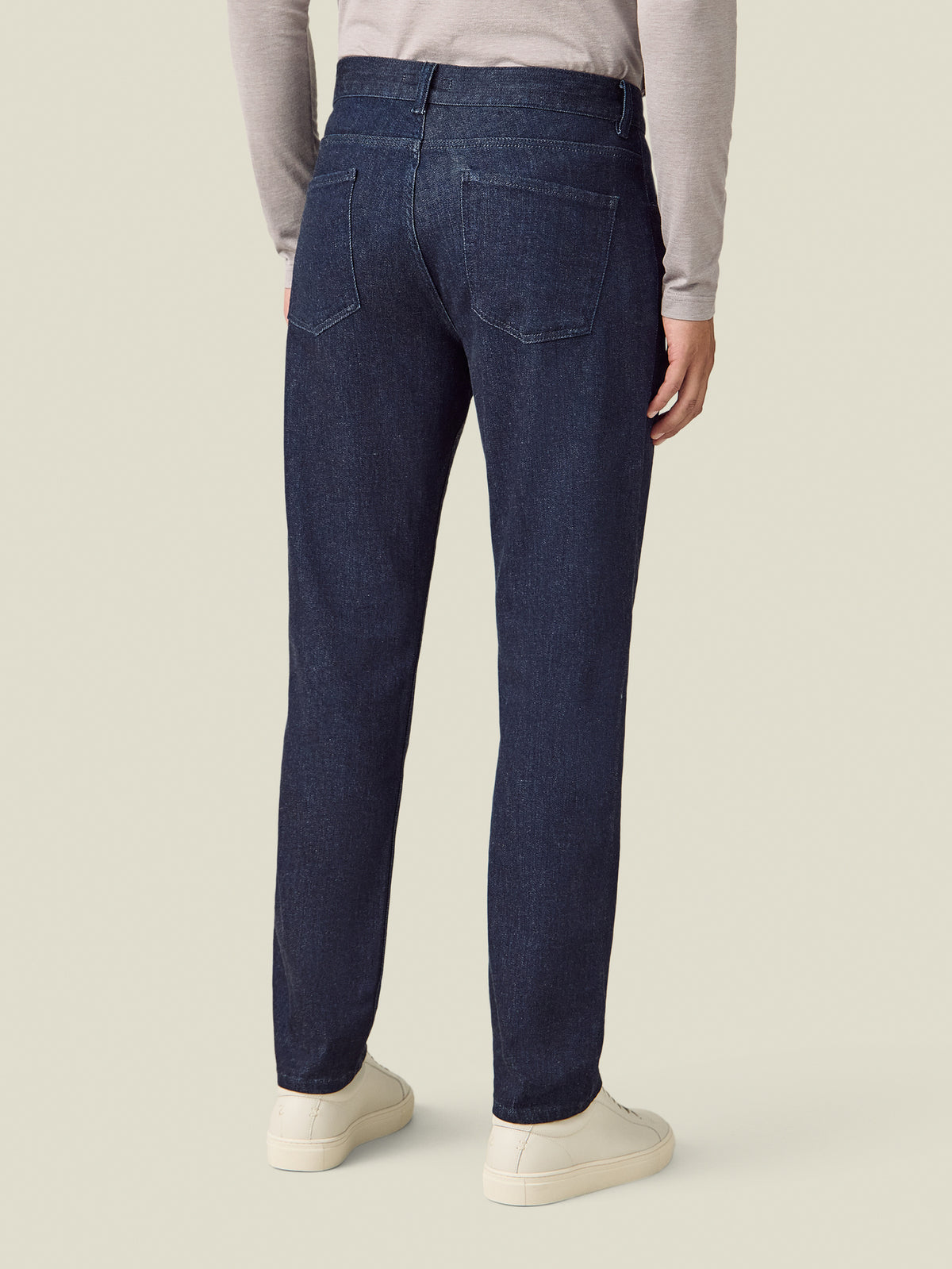 Back view of a model wearing the Luca Faloni Cashmere Denim Jeans in dark blue.